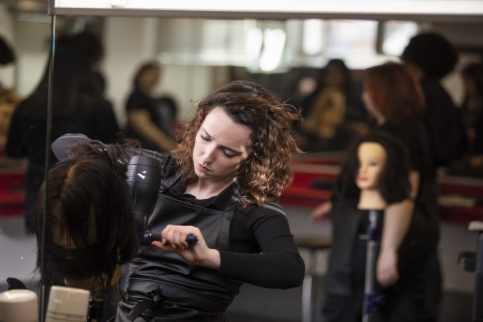 Une jeune en formation en train de s'entrainer sur un mannequin